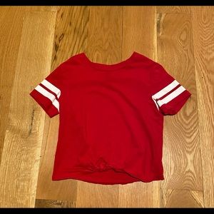 Red and white t- shirt with tie at the bottom.